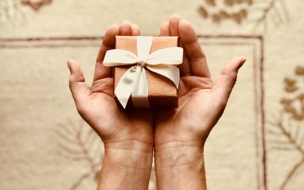 Hands holding a small gift