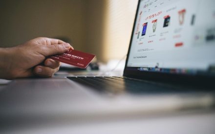 A close up picture of a person using a laptop to shop online